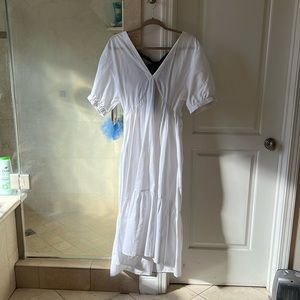White TopShop prairie dress with black tie.